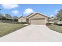 Attractive one-story home with a two-car garage, concrete driveway, and professionally landscaped yard at 6 Diamond Cove Ct, Ocala, FL 34472