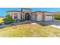 Charming single-story home featuring a well-maintained lawn, manicured shrubs, and a two-car garage at 6558 Sw 94Th Cir, Ocala, FL 34481