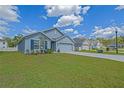 Pleasant one-story residence showcasing an expansive lawn and convenient driveway access at 6933 Se 111Th Ln, Belleview, FL 34420