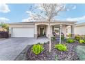 Welcoming single-story home featuring a paver driveway, two-car garage, and beautifully landscaped front yard at 8344 Sw 79Th Cir, Ocala, FL 34476