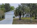 Well-maintained single-story home with an attached garage and beautiful landscaping with a long driveway at 8449 Sw 106Th Pl, Ocala, FL 34481