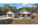 Beautiful single-Gathering home featuring a modern design, garage, and landscaped front yard at 8850 Sw 125Th Ter, Dunnellon, FL 34432