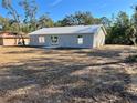 The rear of this single-story home offers a spacious yard ready for landscaping and outdoor enjoyment at 10 Sequoia Trail Ter, Ocklawaha, FL 32179