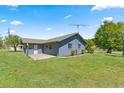 Charming single-story home featuring a well-maintained lawn and mature landscaping at 10690 Se 44Th Ter, Belleview, FL 34420