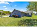 Spacious home showcasing a well-manicured lawn and a two-car garage at 10690 Se 44Th Ter, Belleview, FL 34420