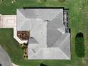 Aerial view of home showcasing the roof, screened patio, and manicured landscaping at 11010 Se 174Th Loop, Summerfield, FL 34491