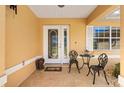 Cozy front porch features a seating area and decorative details that add to the home's curb appeal at 17472 Se 112Th Ct, Summerfield, FL 34491
