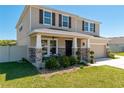 Inviting front porch with stone accents, a cozy seating area, manicured bushes and a well-maintained lawn at 1861 Ne 50Th Ter, Ocala, FL 34470