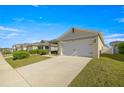 Charming single-Gathering home featuring a two-car garage and landscaped front yard at 29496 Caspian St, Leesburg, FL 34748