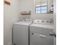 The laundry room features side-by-side washer and dryer at 29496 Caspian St, Leesburg, FL 34748