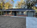 Beautiful single-story home featuring a covered front porch and an attached one car garage at 2983 Se 145Th Pl, Summerfield, FL 34491