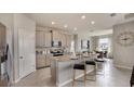 Bright kitchen featuring granite countertops, a breakfast bar, and pendant lighting for a modern touch at 3075 Canopy Oak Blvd, Wildwood, FL 34785