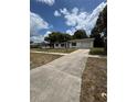 A one-story home with a long driveway and attached garage on a sunny day at 333 Marion Oaks Dr, Ocala, FL 34473