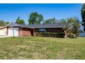 Brick home features a driveway and a well-maintained lawn at 4541 Sw 44Th Ln, Ocala, FL 34474