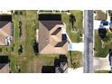 Overhead shot of a residence with a lush lawn and spacious driveway in a quiet neighborhood setting at 5291 Nw 20 Pl, Ocala, FL 34482