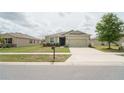 Inviting single-story home with a two-car garage and lush front lawn at 6138 Sw 89Th Lane Rd, Ocala, FL 34476