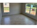 Cozy bedroom with large windows, tiled floors, and white walls perfect for creating a relaxing space at 71 Nw 42Nd Pl, Ocala, FL 34475