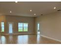 Spacious living room featuring tiled floors, recessed lighting, and backyard access at 71 Nw 42Nd Pl, Ocala, FL 34475
