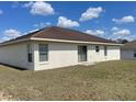 Back exterior featuring siding doors and windows at 8386 Sw 136Th Pl, Ocala, FL 34473
