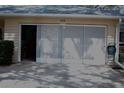 View of the garage with its door, hose, and plumbing at 8569 Sw 92Nd Ln # B, Ocala, FL 34481