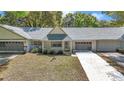 Charming single-story home featuring well-kept landscaping, a gray roof and a welcoming entrance at 8836 Sw 90Th Ln # B, Ocala, FL 34481