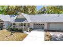 Charming single-story home featuring well-kept landscaping, a gray roof and a welcoming entrance at 8836 Sw 90Th Ln # B, Ocala, FL 34481
