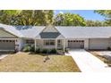 Charming single-story home featuring well-kept landscaping, a gray roof and a welcoming entrance at 8836 Sw 90Th Ln # B, Ocala, FL 34481