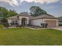 Inviting single-story home with a well-kept lawn and attractive landscaping at 9509 Se 124Th Loop, Summerfield, FL 34491