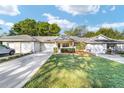 Charming single story home boasts a manicured lawn, attached garage, and covered entryway with space to sit at 9820 Sw 89Th Ter, Ocala, FL 34481