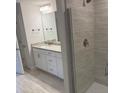 Modern bathroom featuring a tiled shower, granite countertop vanity, and tile flooring at 2166 Nw 23Rd Loop, Ocala, FL 34475