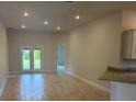 Bright living room with tile flooring, recessed lighting, and access to the backyard at 2166 Nw 23Rd Loop, Ocala, FL 34475