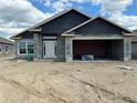 Unfinished exterior of home featuring cinder block walls, covered entry and attached garage at 4522 Sw 90Th Lane Rd, Ocala, FL 34476