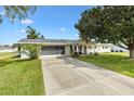 A beautiful residence featuring a pristine driveway, manicured lawn, and a welcoming porch with delightful curb appeal at 10385 Se 178Th St, Summerfield, FL 34491