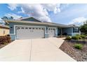 Charming single-story home with a two-car garage and beautifully landscaped front yard and walkway at 10445 Sw 90Th Street Rd, Ocala, FL 34481