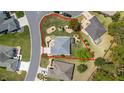 Aerial view of a meticulously landscaped home with a defined property line, offering privacy and curb appeal at 11828 Se 91St Cir, Summerfield, FL 34491