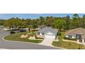 Well-maintained home with lush landscaping, situated on a corner lot with a view of the street at 11828 Se 91St Cir, Summerfield, FL 34491