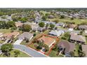 Aerial view showcasing the home's location within a quiet neighborhood and a golf course nearby at 13109 Se 86Th Ct, Summerfield, FL 34491