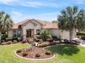 Well-maintained front yard with mature landscaping and a charming, inviting exterior at 13109 Se 86Th Ct, Summerfield, FL 34491