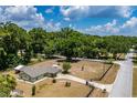 Aerial view of the property with lush greenery and a long driveway at 13300 Ne 38Th Ave, Anthony, FL 32617