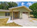 Close-up of the house featuring a stone entryway and attached garage at 13300 Ne 38Th Ave, Anthony, FL 32617