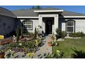 Inviting front entrance with beautiful landscaping, flowerbeds and manicured lawn at 137 Juniper Loop, Ocala, FL 34480