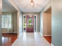 Bright foyer with tile flooring, neutral walls, and a view of the landscaped front yard through the front door at 1505 Se 27Th Ter, Ocala, FL 34471