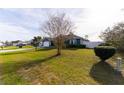 Inviting curb appeal with a neatly landscaped front yard and a charming, single-story home at 16201 Sw 47Th Ter, Ocala, FL 34473