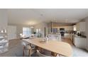 Bright and airy living space with a dining area, kitchen island, and elegantly arranged furnishings at 1698 Ne 161 St, Citra, FL 32113
