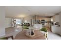 Stylishly staged living area with a dining space, kitchen island, and contemporary decor, creating an inviting atmosphere at 1698 Ne 161 St, Citra, FL 32113