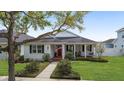 Inviting home with manicured lawn, a cozy front porch, and classic American charm at 1910 Se 28Th Pl, Ocala, FL 34471