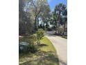 Street view of a lush green yard with mature trees at 19903 Sw 97Th Ln, Dunnellon, FL 34432