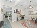 Bright foyer featuring stylish decor, neutral tones, and an open view to the living spaces and staircase at 3920 Se 7Th Ave, Ocala, FL 34480