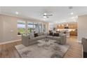 Bright and airy living room showcases an oversized sectional sofa, clear coffee table, and an open floor plan at 4497 Nw 54Th Ter, Ocala, FL 34482