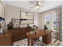 This office features a wooden desk, neutral walls, and a large abstract painting for a serene workspace at 4497 Nw 54Th Ter, Ocala, FL 34482
